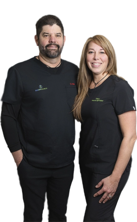 Dr. Mike Shride standing with Tiffany Shride in professional black uniforms.
