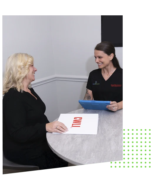 Professional consultation at a clinic table focusing on personalized wellness guidance and evaluation.